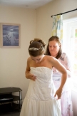Bride getting into wedding dress - Bridal preparation at Mulberry House